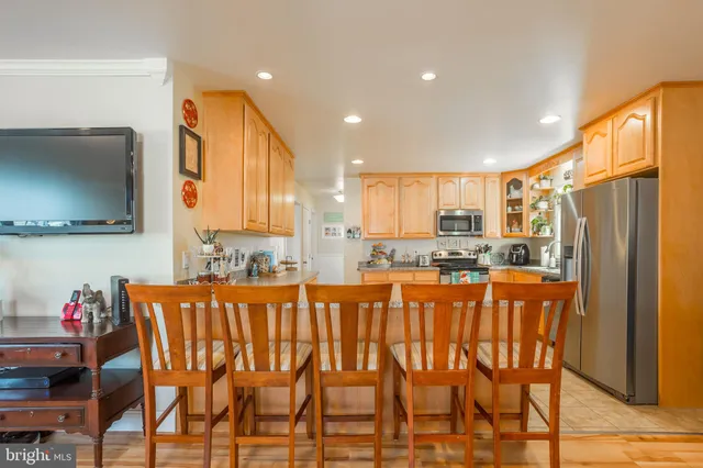 a dining table chairs and a refrigerator