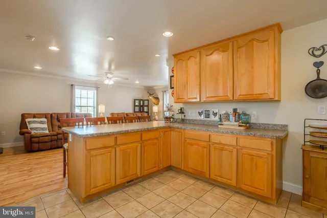 a large kitchen with stainless steel appliances granite countertop a sink and cabinets