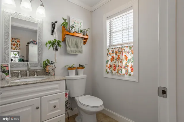 a bathroom with a toilet a sink and a window