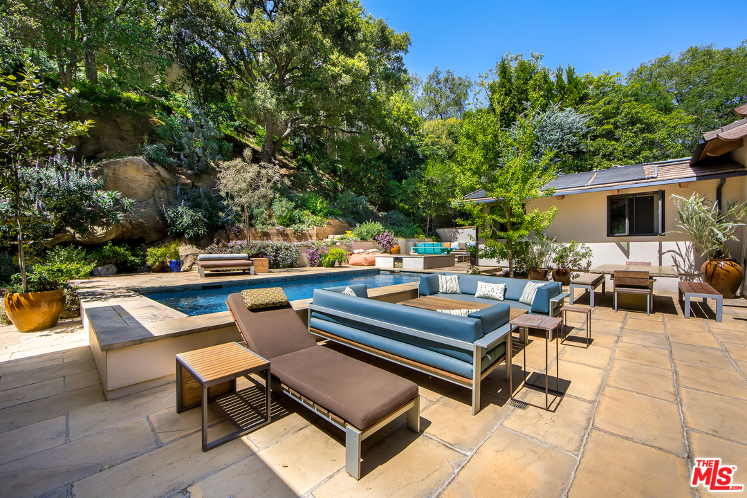 1787 Old Ranch Road Los Angeles, CA 90049 - Photo 11 of 54 a outdoor sitting area with furniture and a potted plant