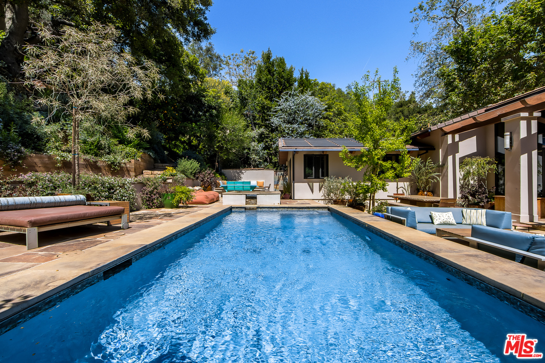 1787 Old Ranch Road Los Angeles, CA 90049 - Photo 12 of 54 a swimming pool with outdoor seating and yard
