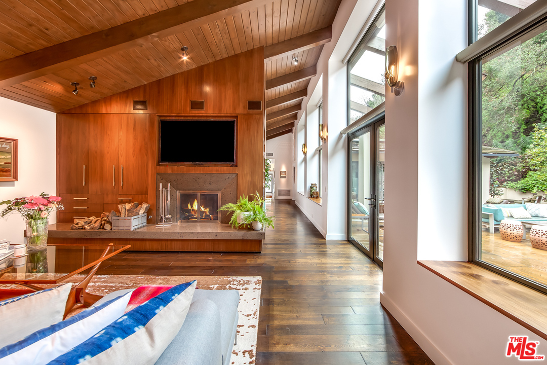 1787 Old Ranch Road Los Angeles, CA 90049 - Photo 20 of 54 a living room with fireplace furniture and a flat screen tv
