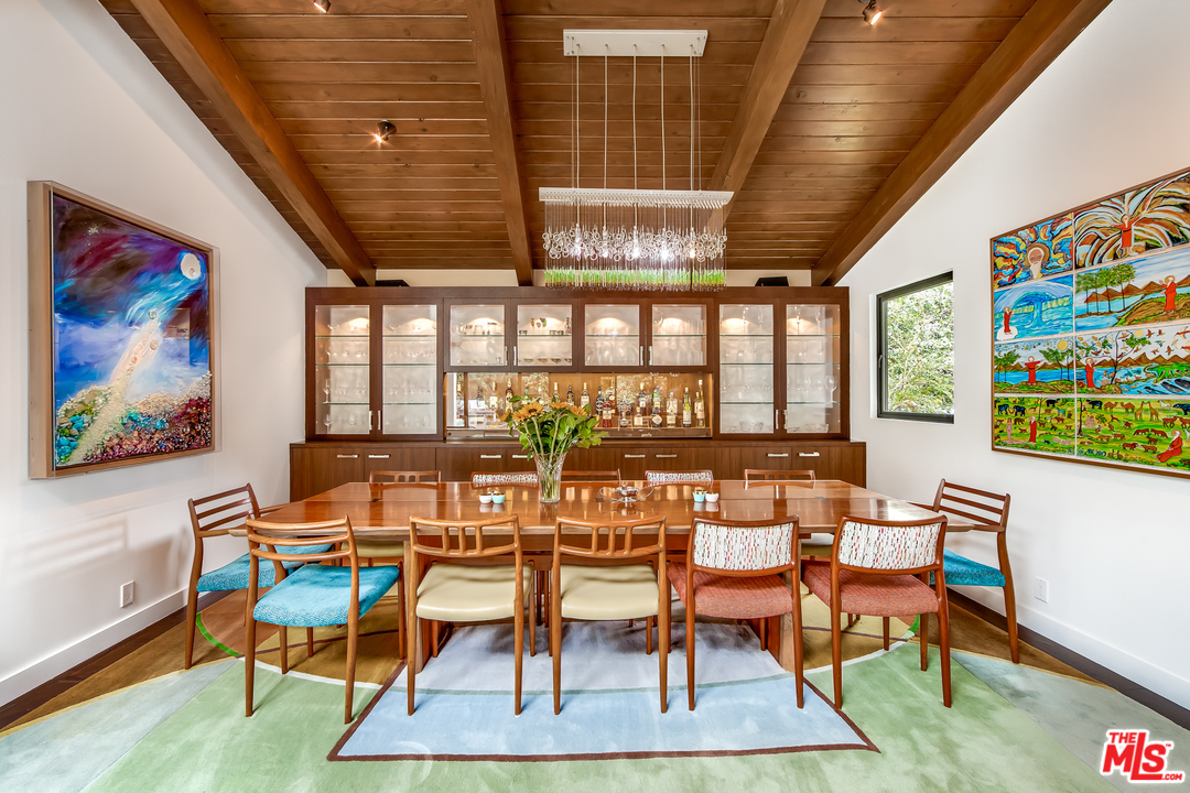 1787 Old Ranch Road Los Angeles, CA 90049 - Photo 22 of 54 a dining room with furniture a rug and wooden floor