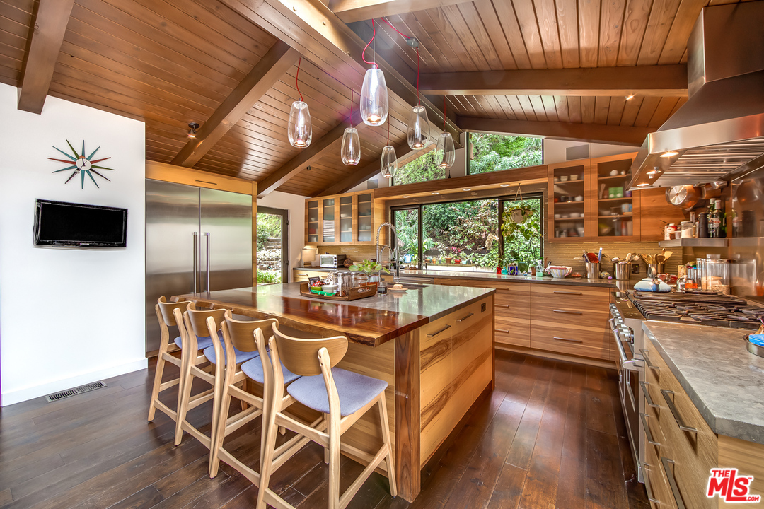 1787 Old Ranch Road Los Angeles, CA 90049 - Photo 25 of 54 a view of a kitchen with stainless steel appliances granite countertop a stove and a wooden floors