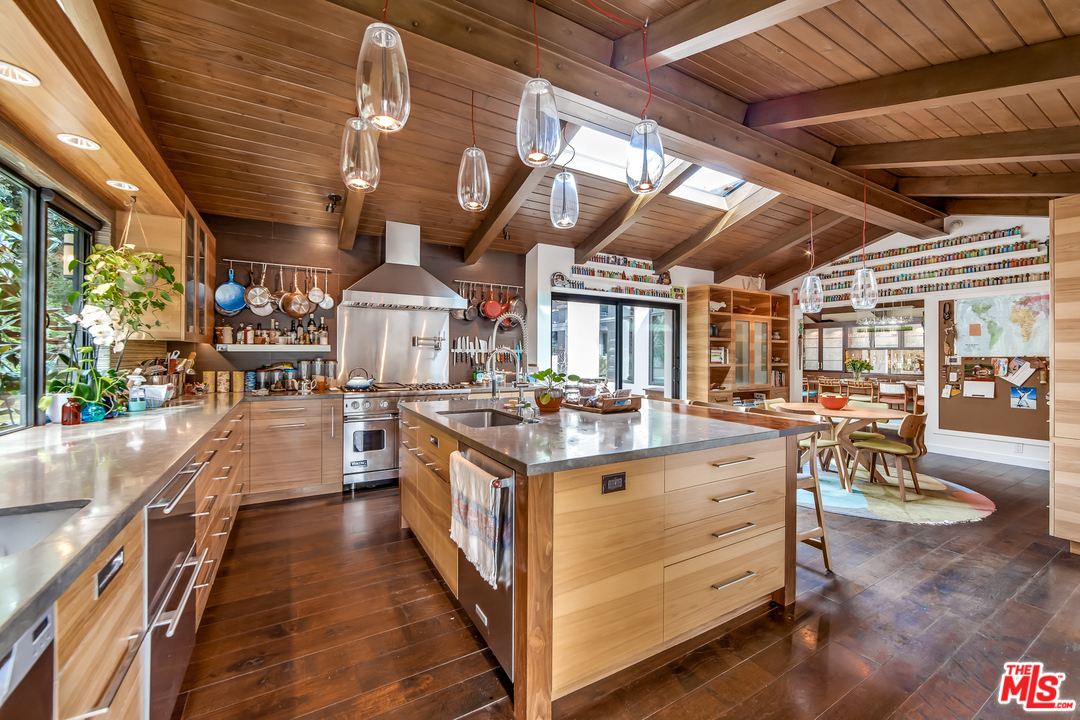 1787 Old Ranch Road Los Angeles, CA 90049 - Photo 27 of 54 a view of a kitchen with stove and chairs