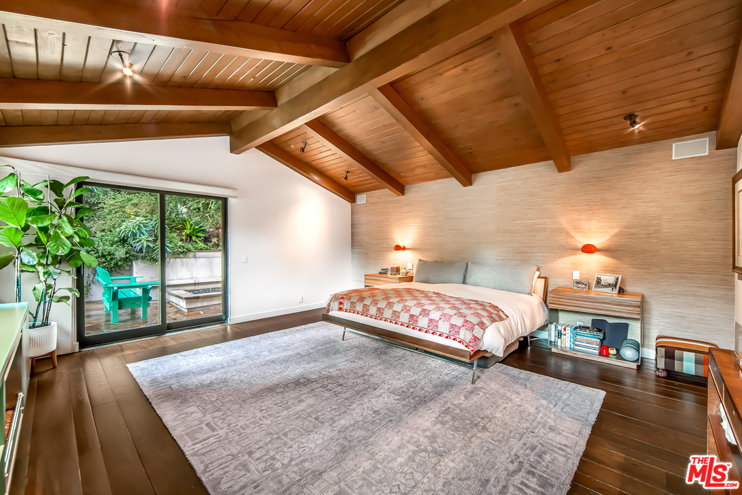 1787 Old Ranch Road Los Angeles, CA 90049 - Photo 28 of 54 a bedroom with furniture and a wooden floor