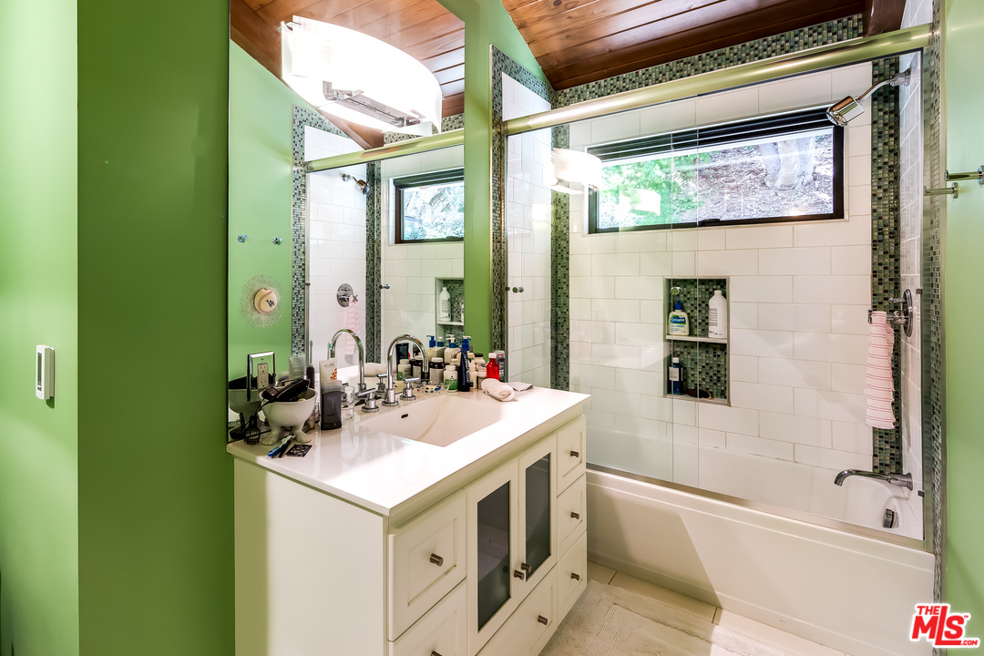 1787 Old Ranch Road Los Angeles, CA 90049 - Photo 37 of 54 a bathroom with a sink and a mirror