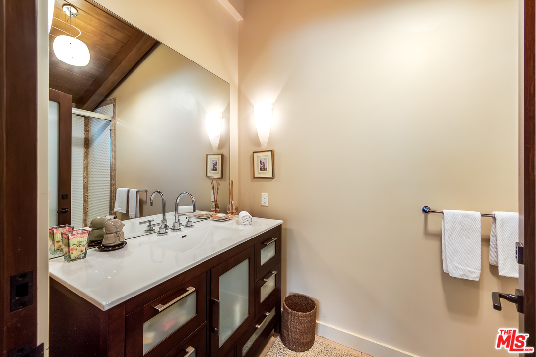1787 Old Ranch Road Los Angeles, CA 90049 - Photo 39 of 54 a bathroom with a sink and a mirror