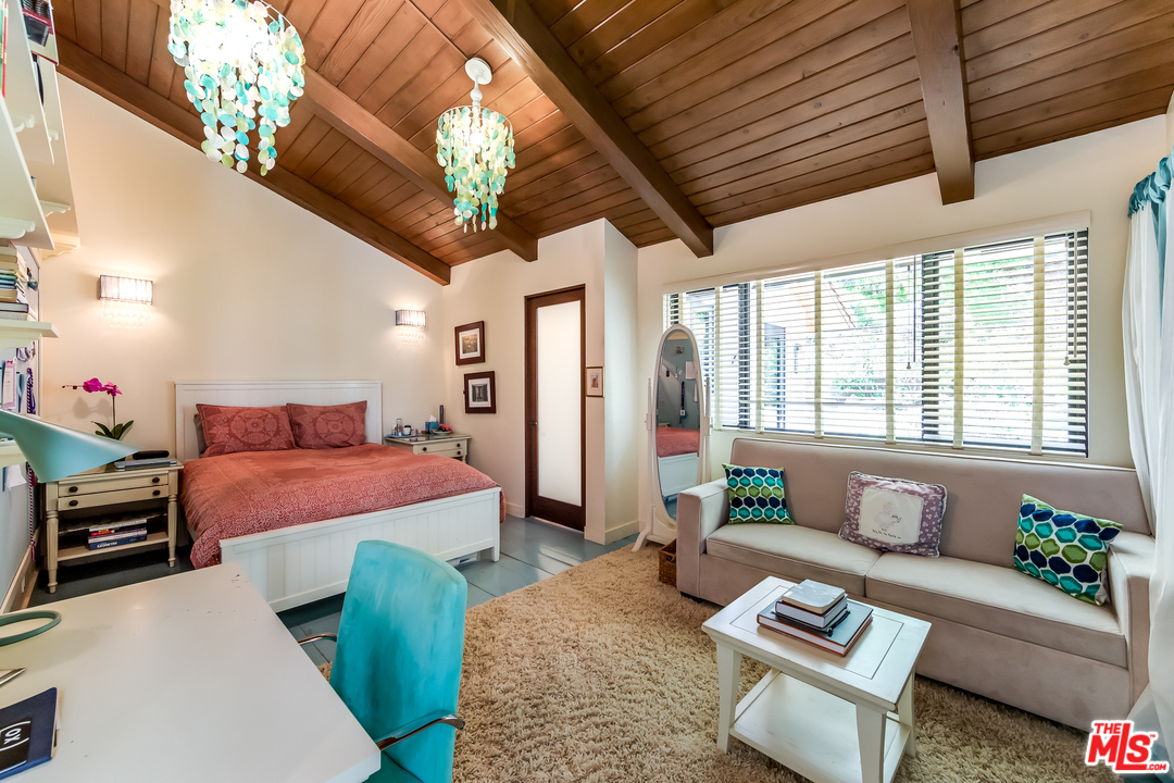 1787 Old Ranch Road Los Angeles, CA 90049 - Photo 40 of 54 a bedroom with furniture and a large window