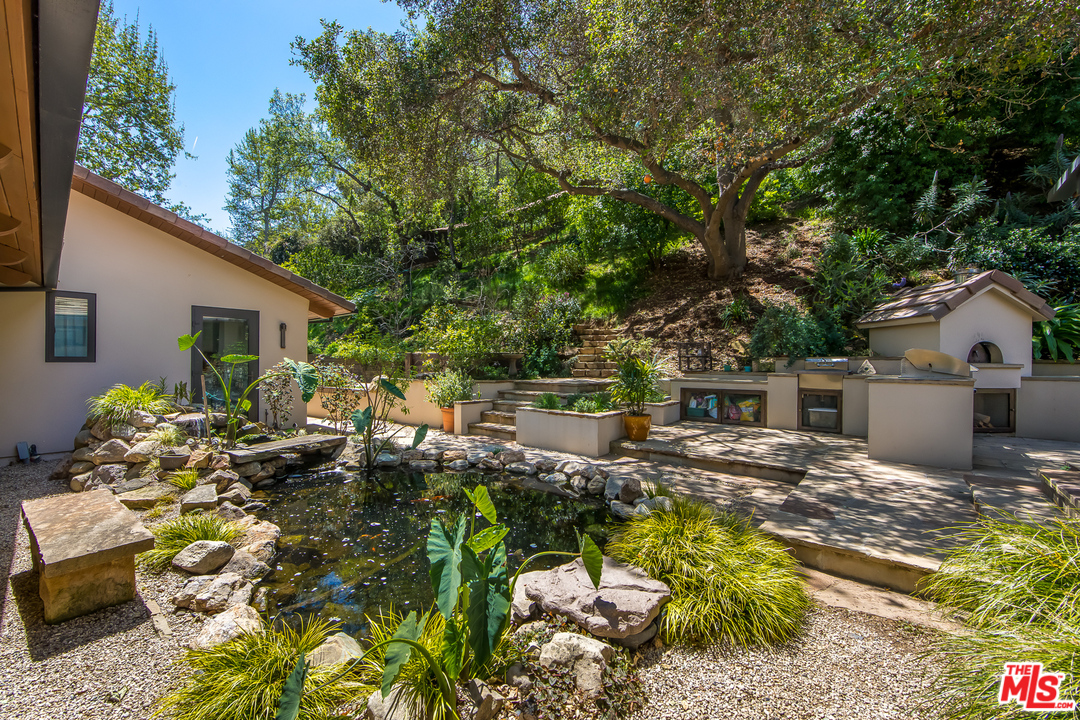 1787 Old Ranch Road Los Angeles, CA 90049 - Photo 44 of 54 a view of a house with backyard sitting area and swimming pool