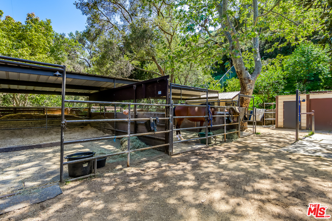 1787 Old Ranch Road Los Angeles, CA 90049 - Photo 46 of 54 a view of a chairs and table in the backyard