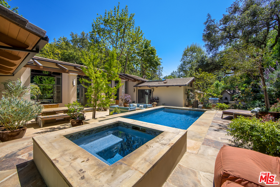 1787 Old Ranch Road Los Angeles, CA 90049 - Photo 49 of 54 a view of a house with pool and sitting area