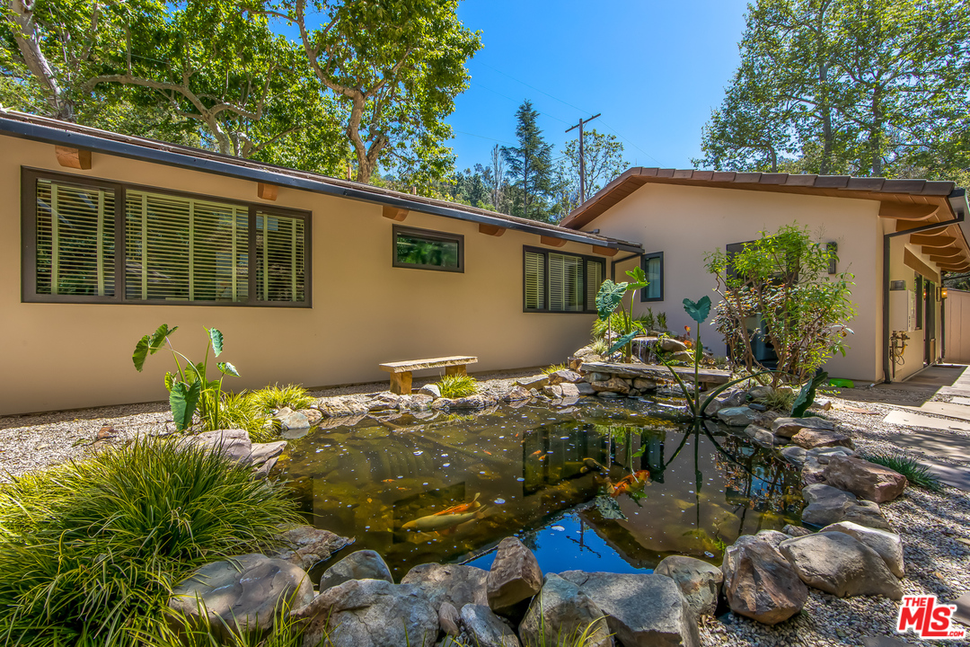 1787 Old Ranch Road Los Angeles, CA 90049 - Photo 6 of 54 a backyard of a house with table and chairs