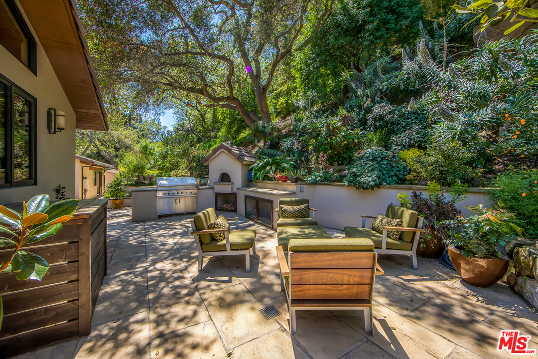 1787 Old Ranch Road Los Angeles, CA 90049 - Photo 8 of 54 a view of a roof deck with couches and potted plants
