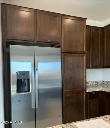 a kitchen with metallic refrigerator freezer and a dishwasher