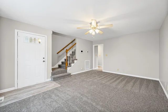 a view of an empty room with a ceiling fan