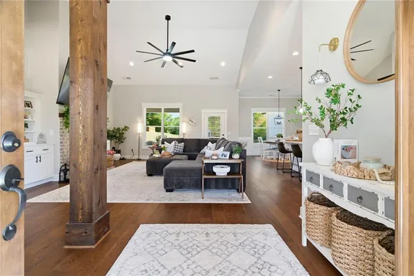 a living room with furniture and a chandelier
