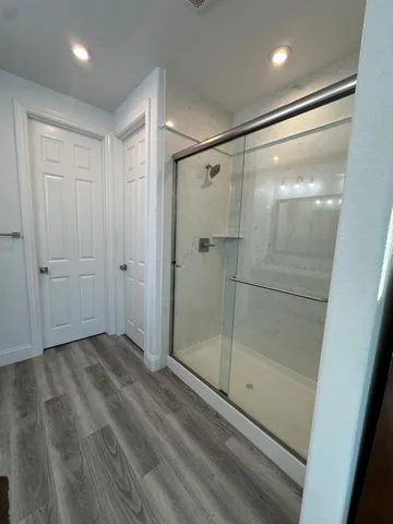 a spacious bathroom with a double vanity sink and mirror