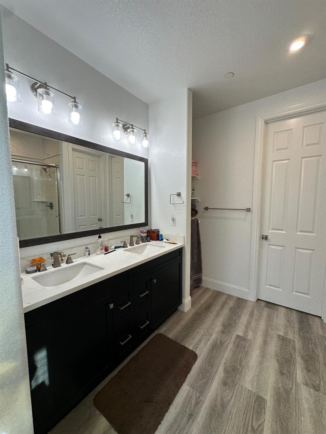 10113 Wayfaring Drive Stockton, CA 95219 - Photo 14 of 26 a spacious bathroom with a double vanity sink and mirror