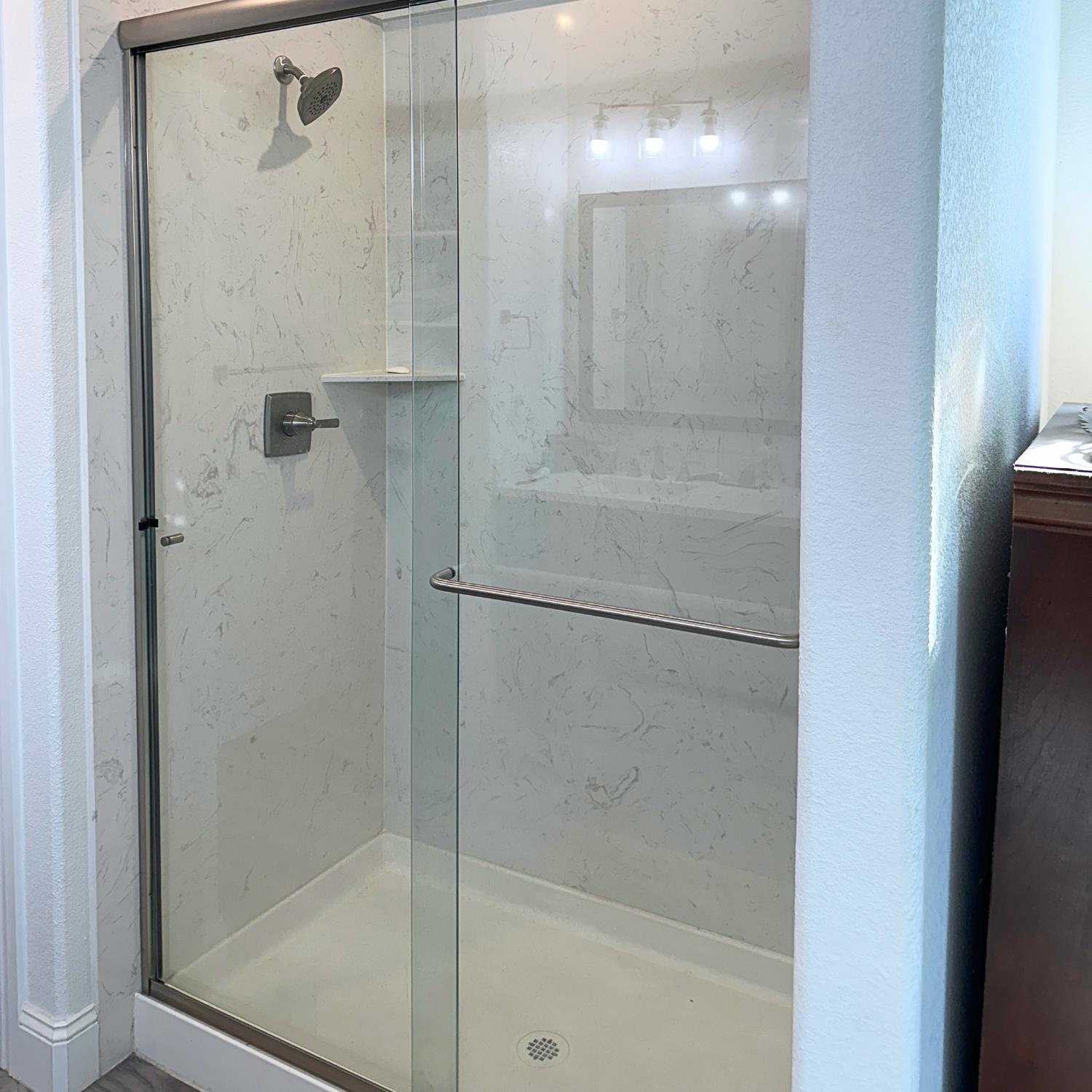10113 Wayfaring Drive Stockton, CA 95219 - Photo 17 of 26 a bathroom with a glass shower door