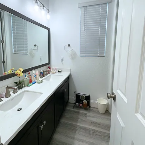 a bathroom with a double vanity sink and a mirror