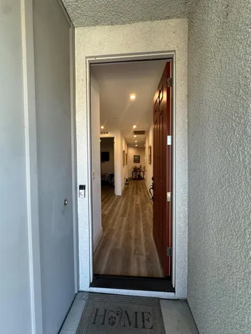 a view of a hallway with a living room