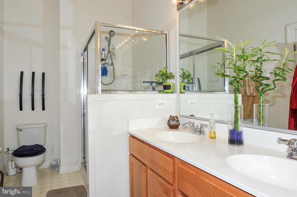 6625 Debra Lu Way Springfield, VA 22150 - Photo 16 of 26 a bathroom with a sink a toilet and mirror
