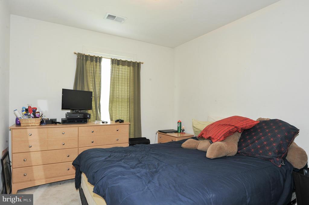 6625 Debra Lu Way Springfield, VA 22150 - Photo 18 of 26 a bedroom with a bed and a flat screen tv