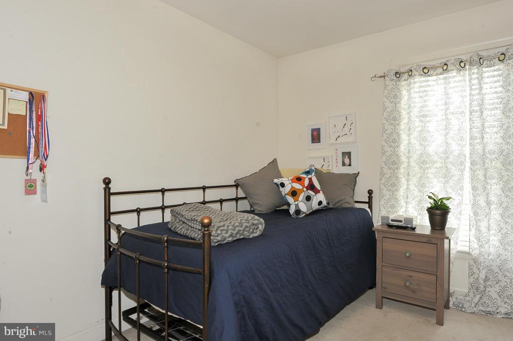 6625 Debra Lu Way Springfield, VA 22150 - Photo 19 of 26 a bed room with furniture and a window