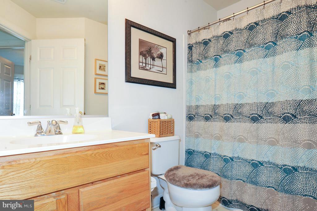 6625 Debra Lu Way Springfield, VA 22150 - Photo 20 of 26 a bathroom with a sink mirror vanity and toilet