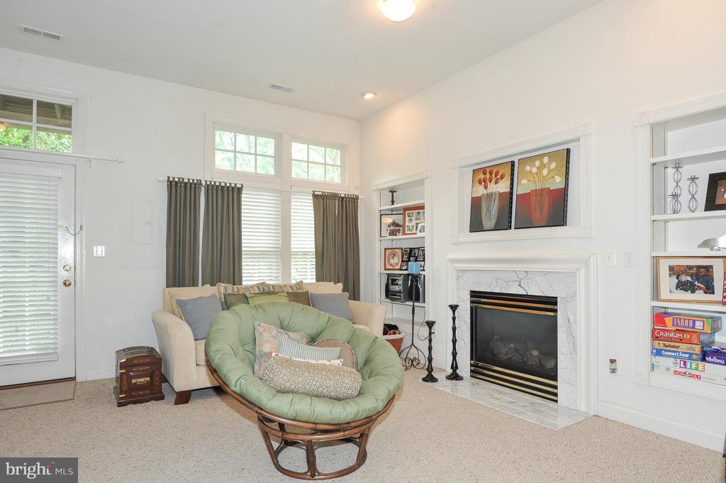6625 Debra Lu Way Springfield, VA 22150 - Photo 23 of 26 a living room with furniture and a fireplace