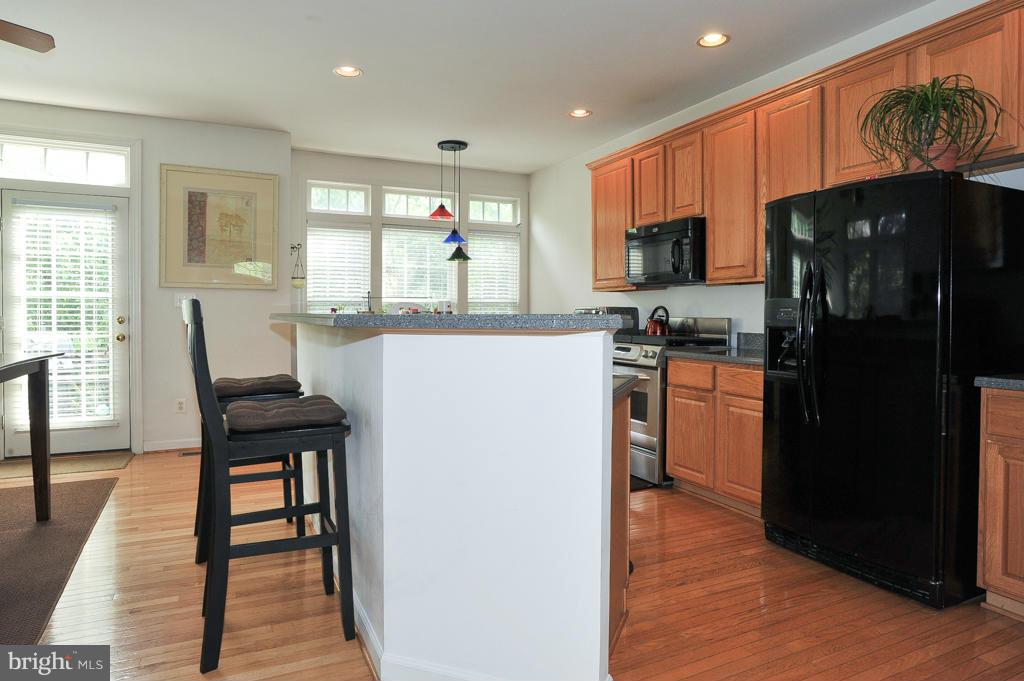 6625 Debra Lu Way Springfield, VA 22150 - Photo 7 of 26 a kitchen with granite countertop a refrigerator stove top oven and sink