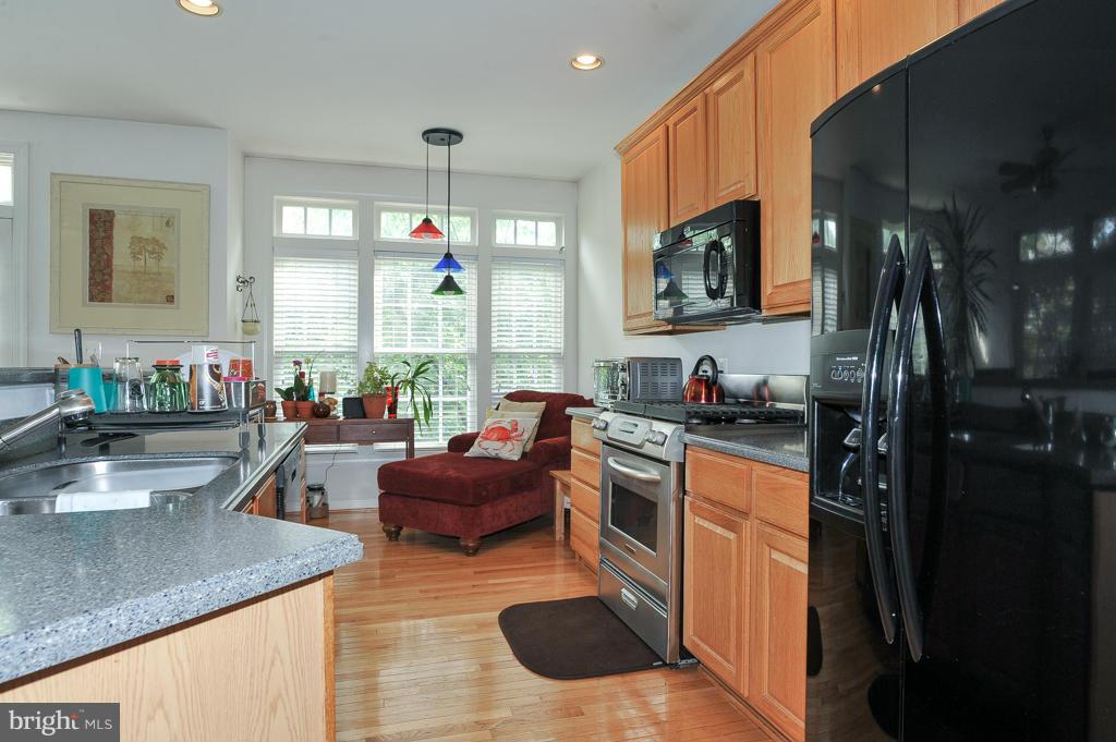 6625 Debra Lu Way Springfield, VA 22150 - Photo 10 of 26 a kitchen with stainless steel appliances granite countertop a sink stove and refrigerator