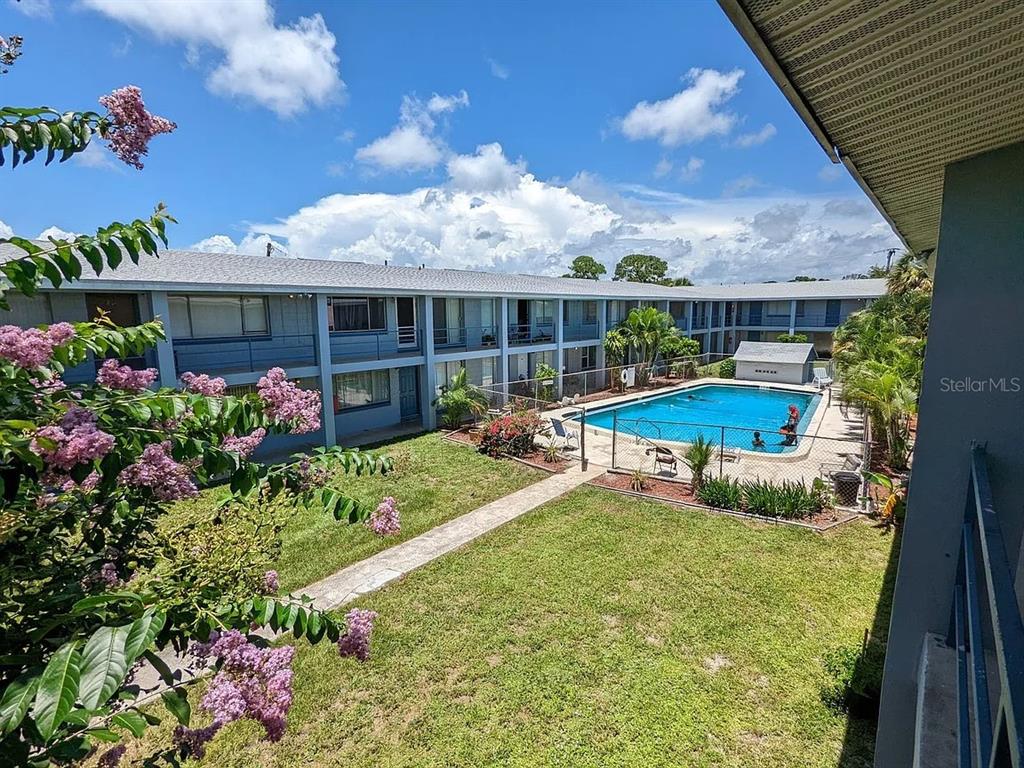a view of a house with backyard sitting area and garden