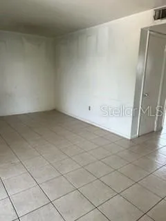 a kitchen with white cabinets and appliances