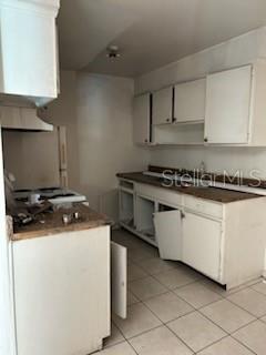 140 Minna Lane, Unit 214 Merritt Island, FL 32953 - Photo 3 of 6 a kitchen with white cabinets and appliances