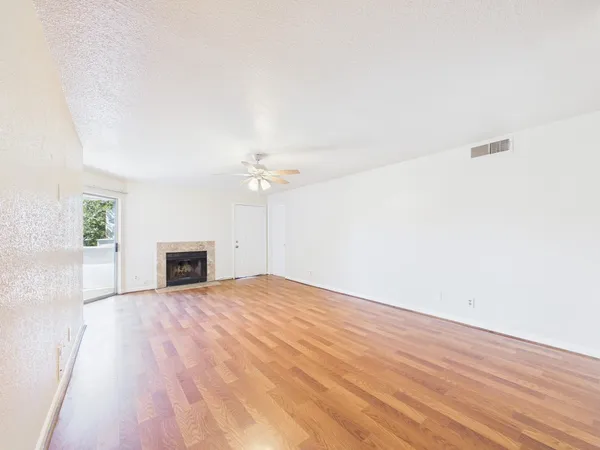 a view of a livingroom with an empty space and a fireplace