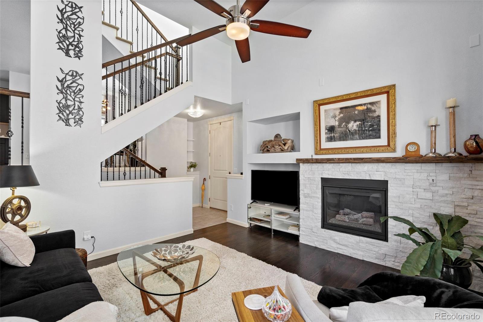1124 Rockhurst Drive, Unit A Highlands Ranch, CO 80129 - Photo 2 of 45 a living room with furniture and a fireplace