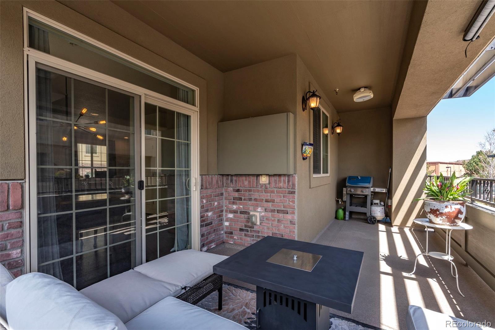 1124 Rockhurst Drive, Unit A Highlands Ranch, CO 80129 - Photo 22 of 45 a view of a patio with couches table and chairs and potted plants