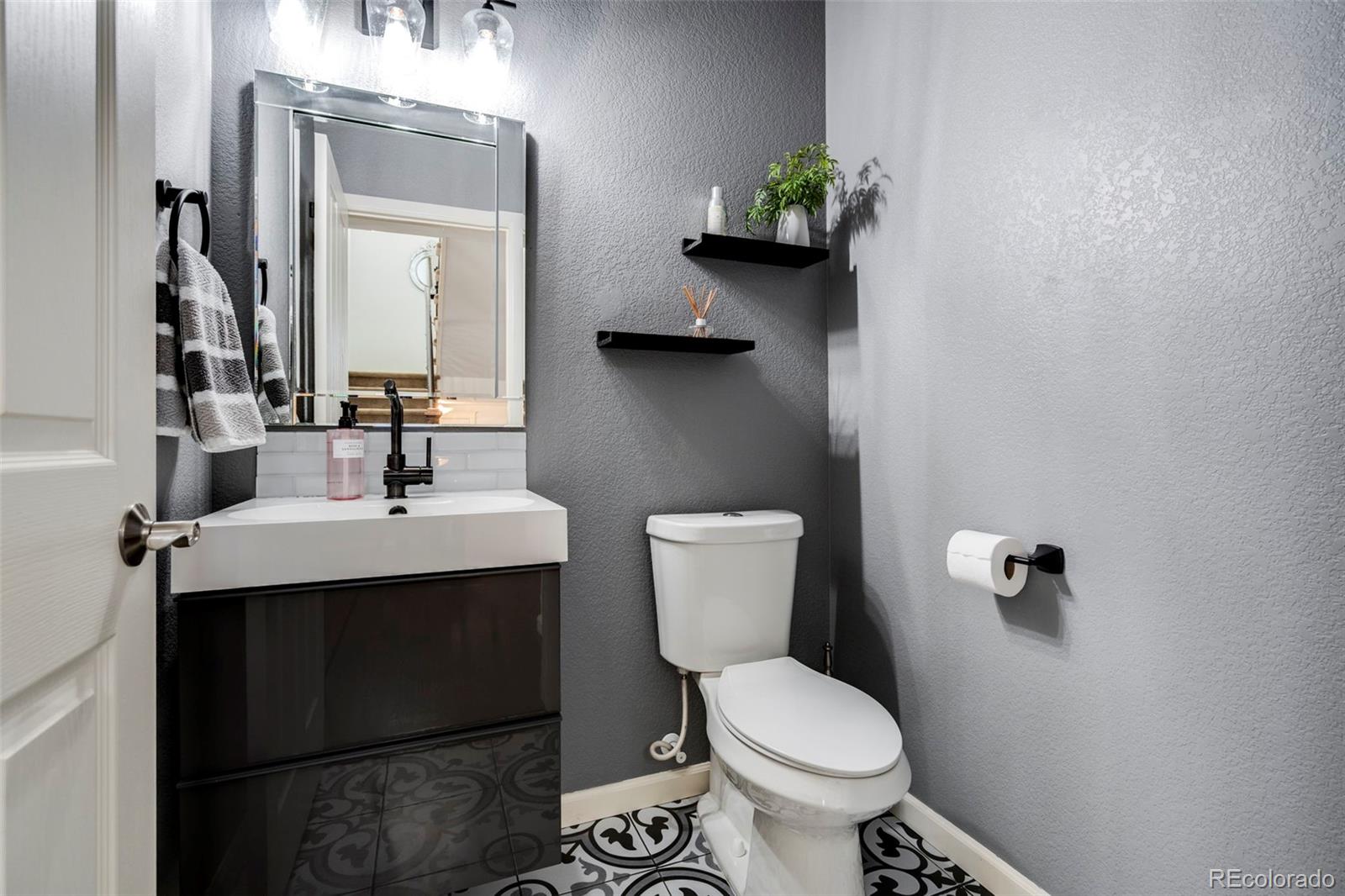1124 Rockhurst Drive, Unit A Highlands Ranch, CO 80129 - Photo 23 of 45 a bathroom with a toilet sink and mirror