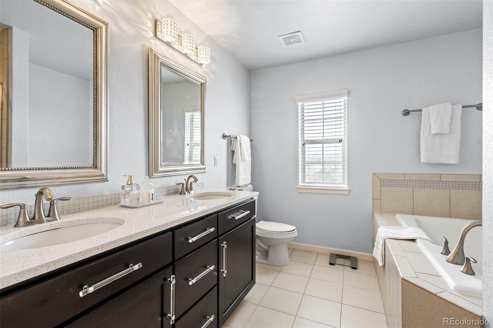 1124 Rockhurst Drive, Unit A Highlands Ranch, CO 80129 - Photo 27 of 45 a bathroom with a sink vanity granite and toilet