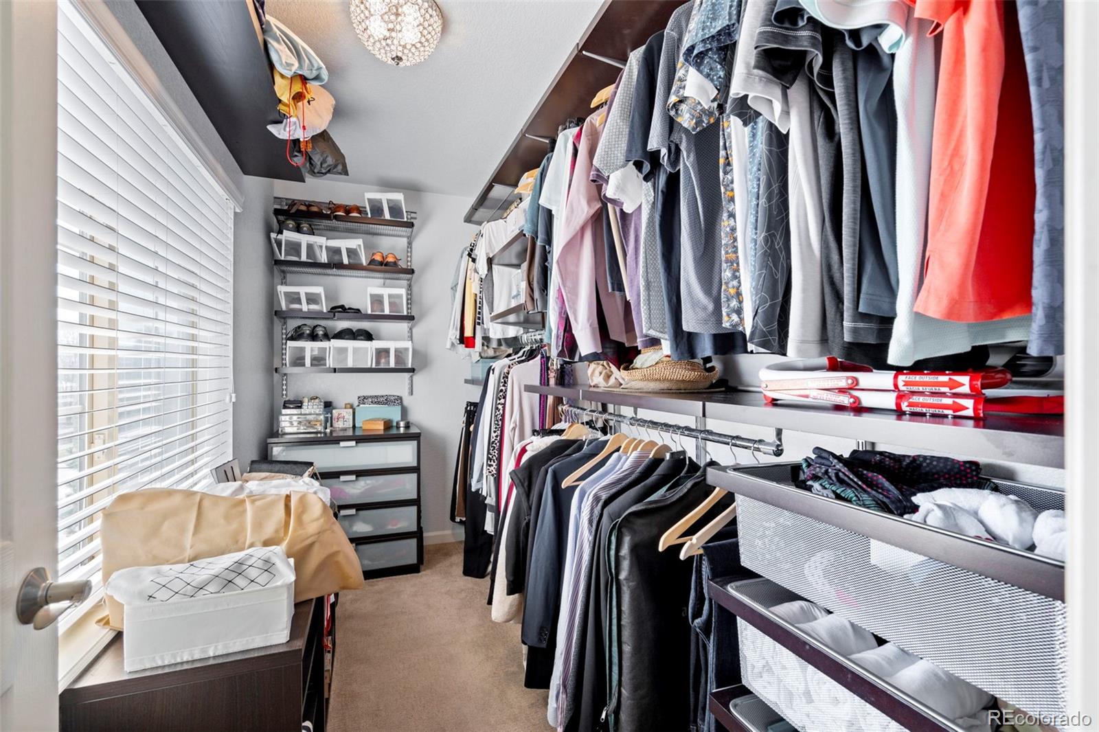 1124 Rockhurst Drive, Unit A Highlands Ranch, CO 80129 - Photo 29 of 45 a view of walk in closet with clothes and shoes