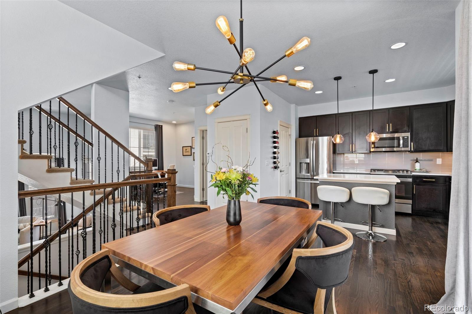 1124 Rockhurst Drive, Unit A Highlands Ranch, CO 80129 - Photo 6 of 45 a kitchen with furniture wooden floor dining table and stainless steel appliances