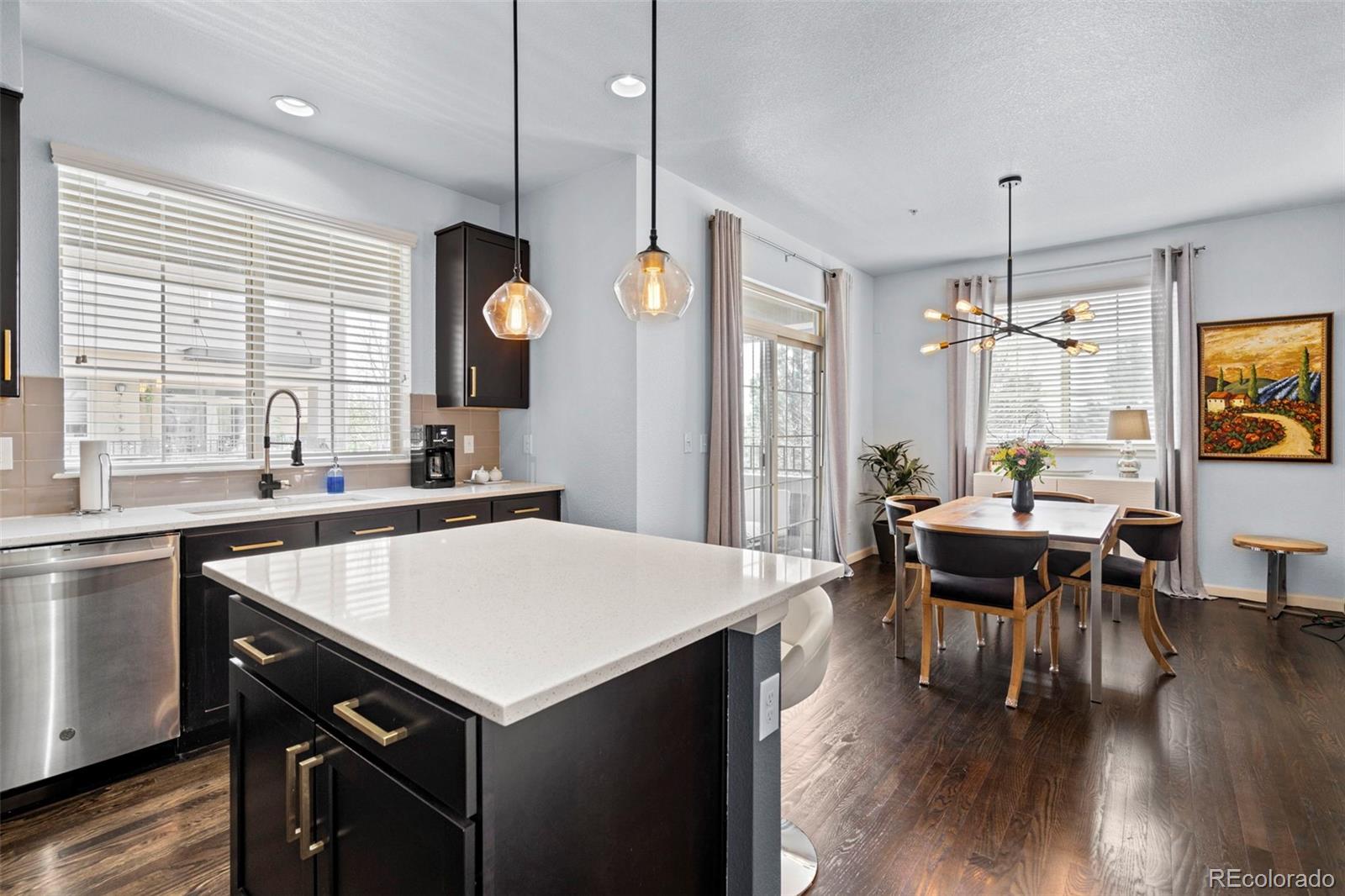1124 Rockhurst Drive, Unit A Highlands Ranch, CO 80129 - Photo 8 of 45 a kitchen with a table chairs and wooden floor