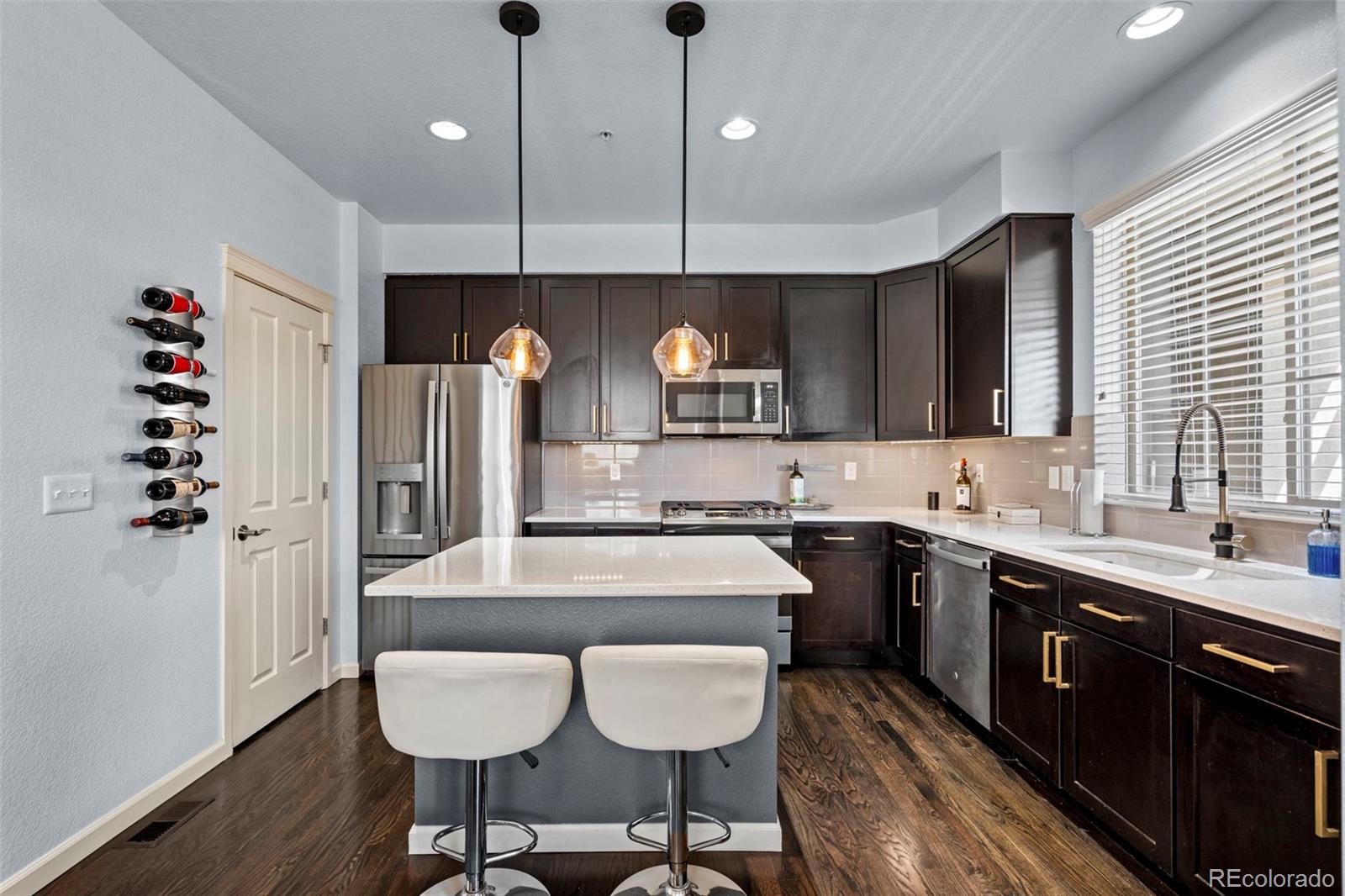 1124 Rockhurst Drive, Unit A Highlands Ranch, CO 80129 - Photo 10 of 45 a kitchen with a dining table chairs cabinets and stainless steel appliances