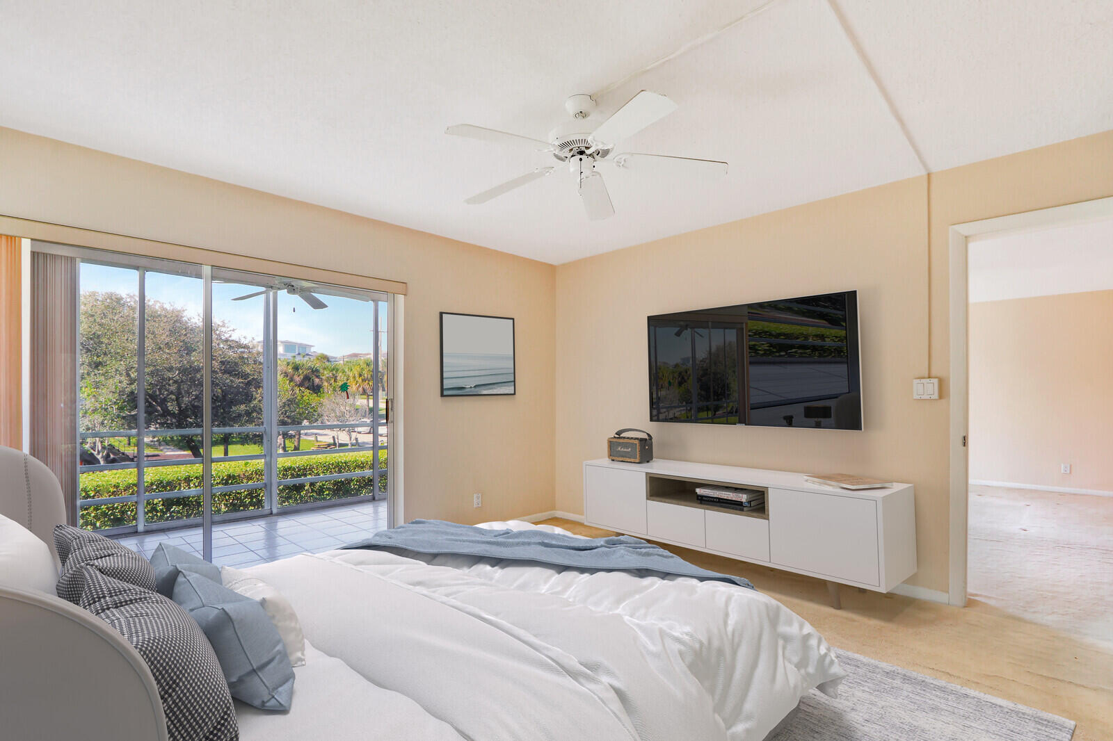 20 Celestial Way, Unit 214 Juno Beach, FL 33408 - Photo 12 of 33 a bedroom with a bed and a flat screen tv