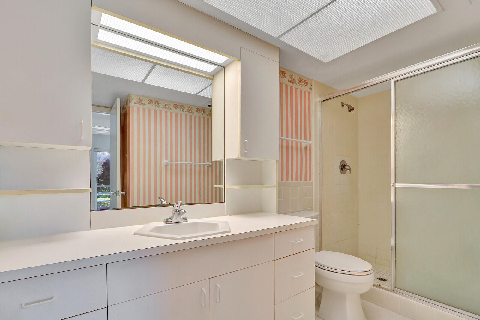 20 Celestial Way, Unit 214 Juno Beach, FL 33408 - Photo 13 of 33 a bathroom with a sink a toilet and shower