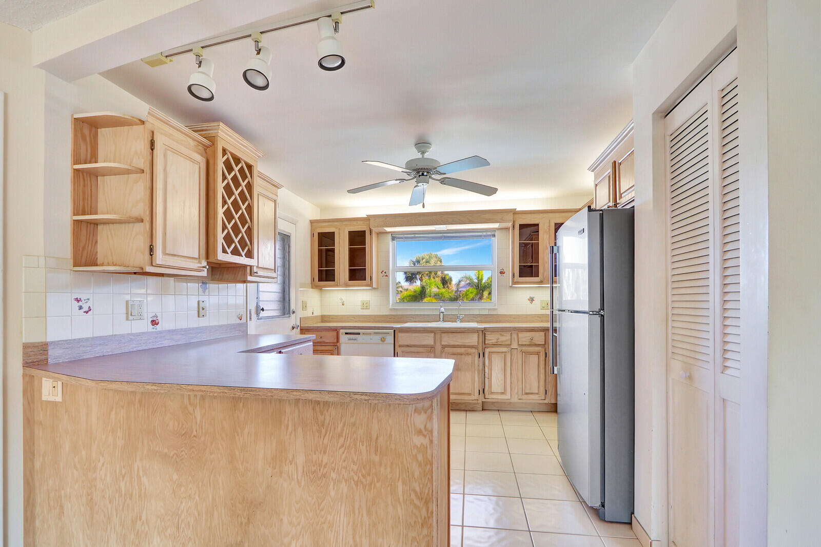 20 Celestial Way, Unit 214 Juno Beach, FL 33408 - Photo 10 of 33 a kitchen with stainless steel appliances granite countertop a sink and a refrigerator