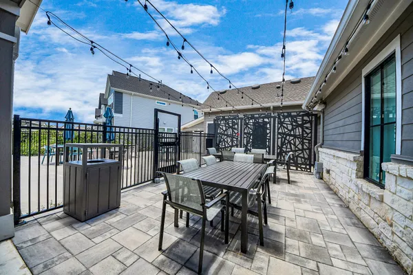 a view of a roof deck with table and chairs