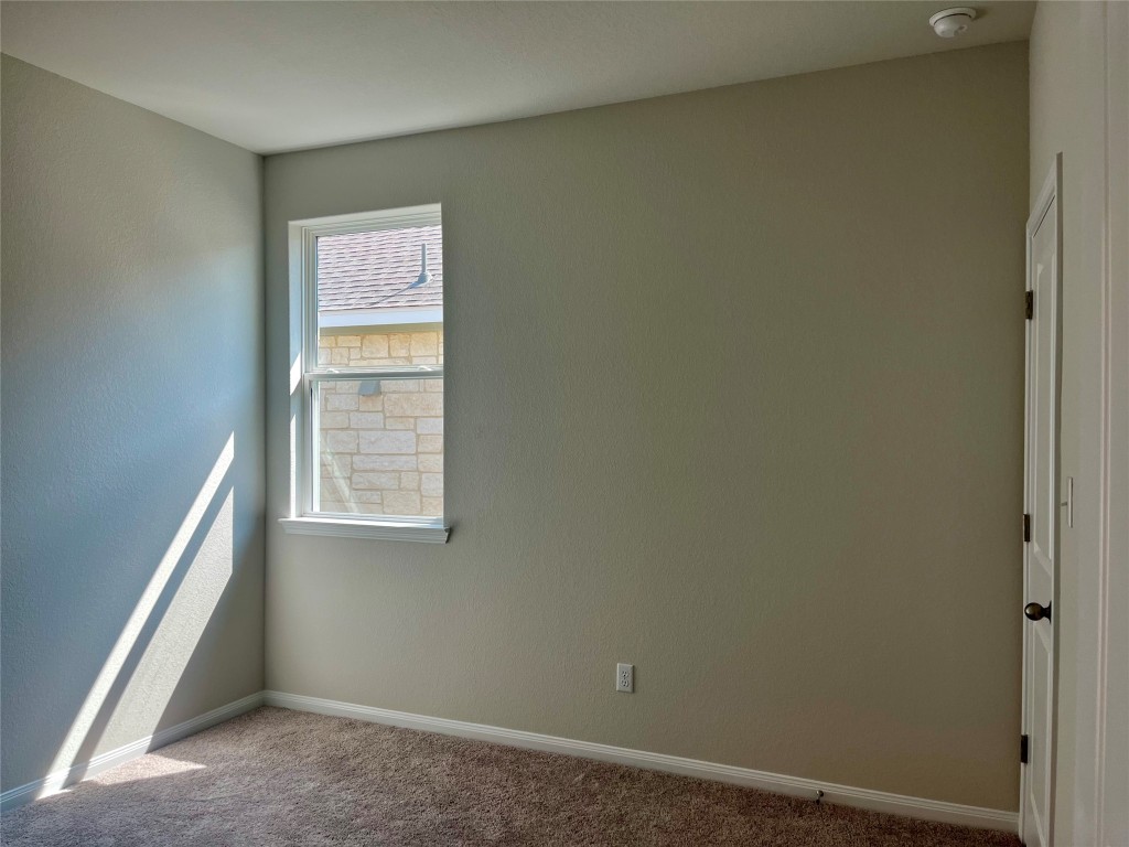 254 Brave Street Kyle, TX 78640 - Photo 14 of 23 Bedroom 3 with walk-in closet